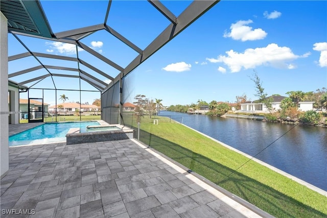 view of pool with an in ground hot tub, a lanai, a water view, a lawn, and a patio area