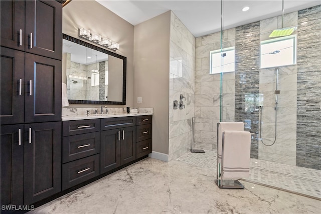 bathroom featuring a shower with door and vanity