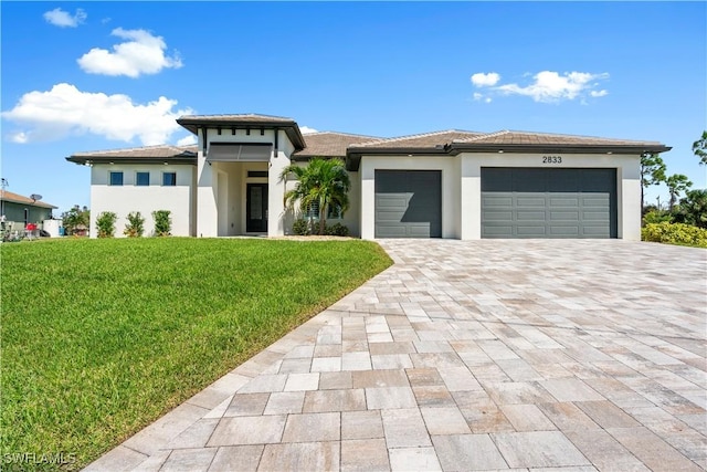 prairie-style house with a front yard and a garage