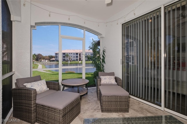 sunroom / solarium featuring a water view