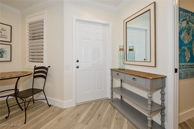 entrance foyer featuring crown molding and light wood-type flooring