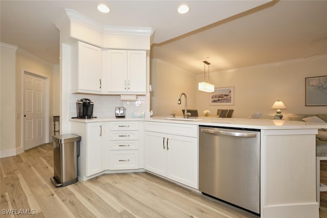 kitchen featuring kitchen peninsula, hanging light fixtures, white cabinetry, stainless steel dishwasher, and sink