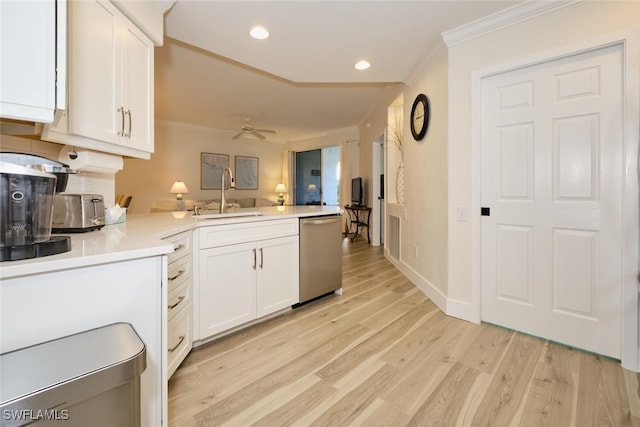 kitchen with kitchen peninsula, white cabinetry, stainless steel dishwasher, light hardwood / wood-style floors, and sink