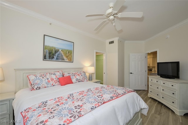 bedroom with ceiling fan, ornamental molding, and light wood-type flooring