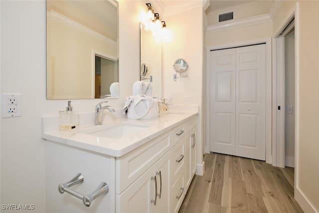 bathroom featuring vanity, crown molding, and hardwood / wood-style floors