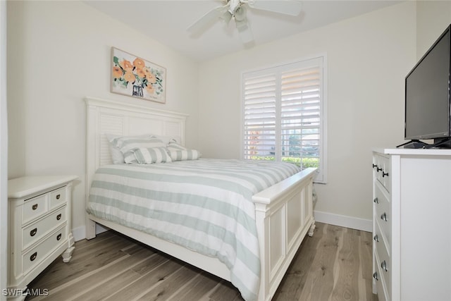 bedroom with light hardwood / wood-style floors and ceiling fan