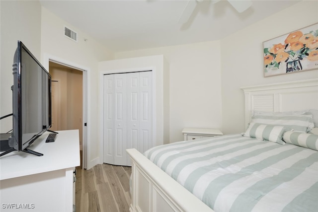 bedroom with a closet, light wood-type flooring, and ceiling fan