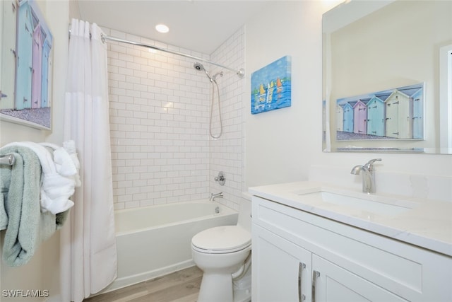 full bathroom featuring toilet, shower / bath combo, hardwood / wood-style flooring, and vanity