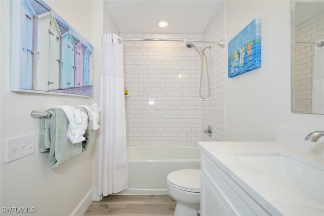 full bathroom with vanity, toilet, hardwood / wood-style flooring, and shower / tub combo