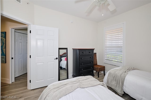 bedroom with wood-type flooring and ceiling fan