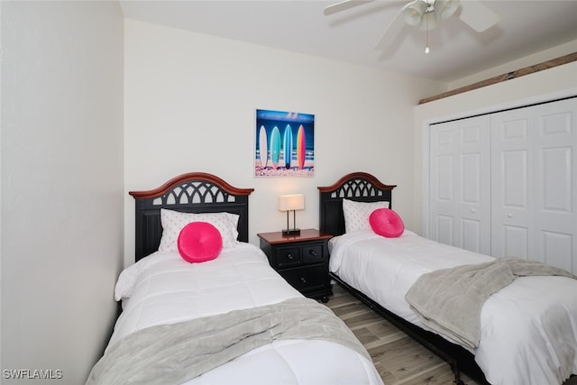 bedroom with hardwood / wood-style flooring, a closet, and ceiling fan