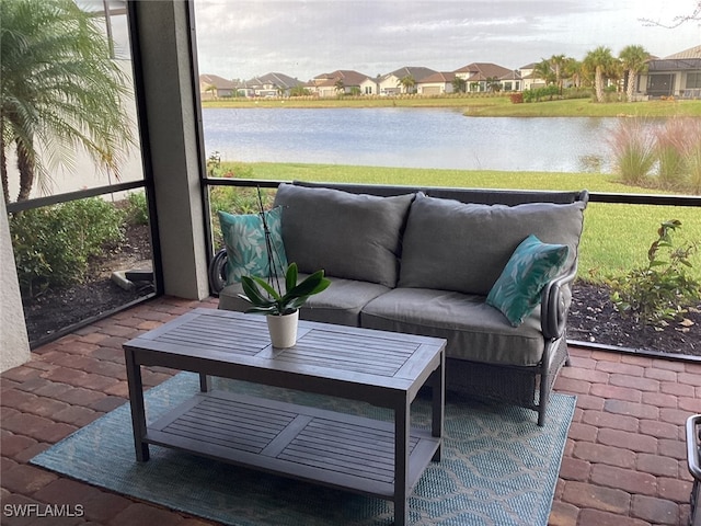 sunroom / solarium with a water view