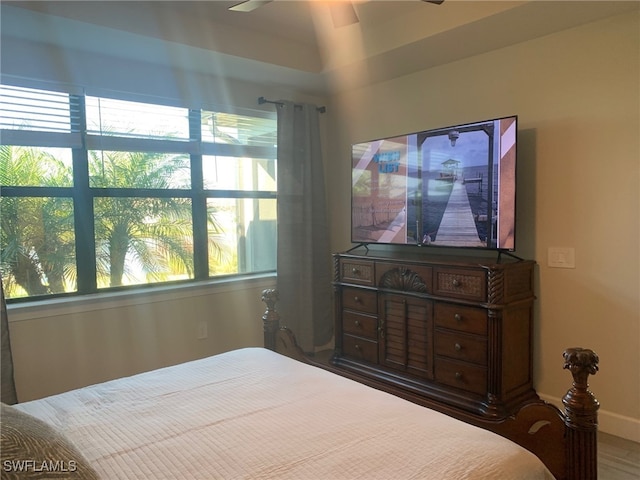 bedroom with ceiling fan and multiple windows