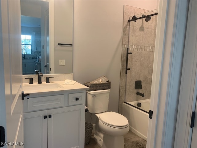 full bathroom featuring vanity, toilet, and tiled shower / bath