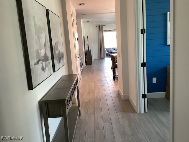 hall with light hardwood / wood-style flooring