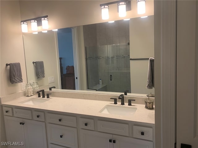 bathroom featuring vanity and a shower with shower door