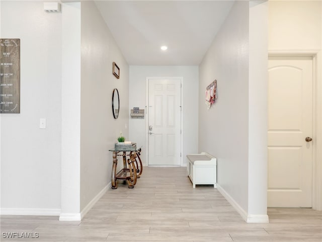 corridor with light hardwood / wood-style flooring