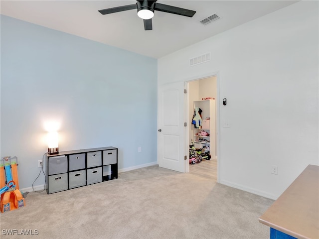 interior space featuring light carpet and ceiling fan