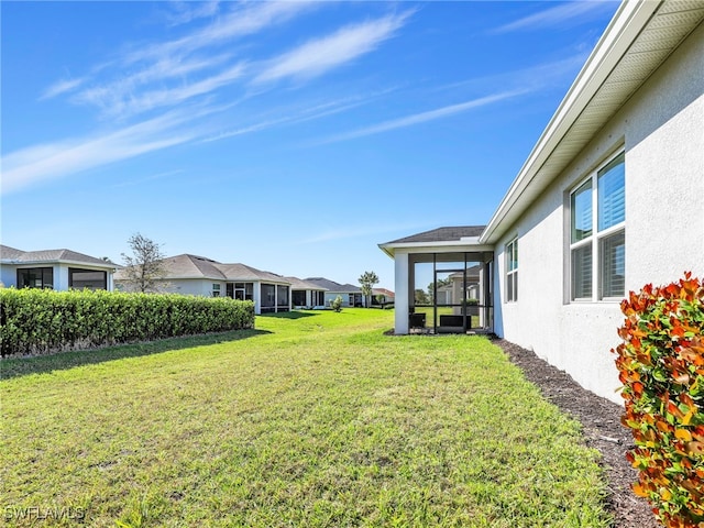 view of yard with a sunroom