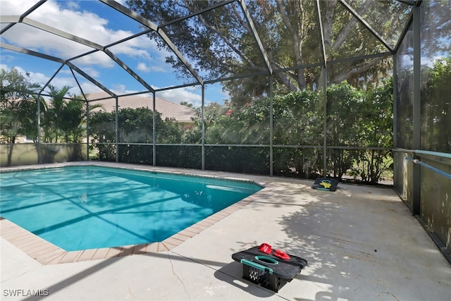 view of pool with a patio and a lanai