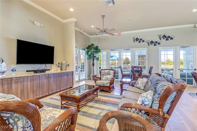 living room featuring french doors, crown molding, light tile patterned flooring, a towering ceiling, and ceiling fan