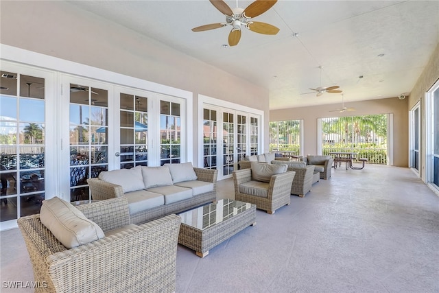 sunroom / solarium featuring french doors and ceiling fan