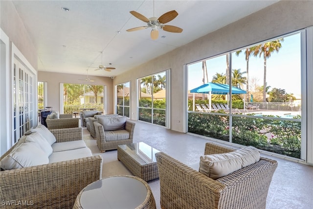 sunroom featuring a healthy amount of sunlight and ceiling fan