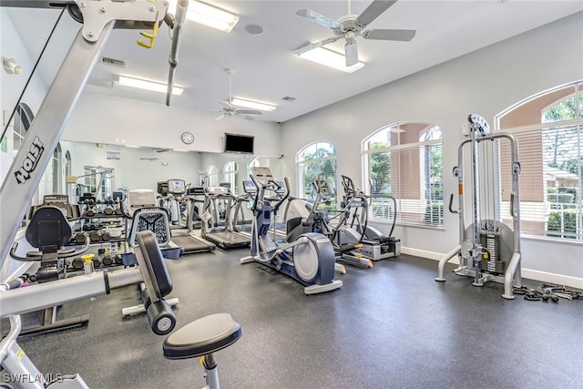 gym with ceiling fan and a healthy amount of sunlight