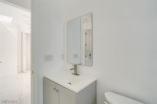 bathroom featuring toilet and vanity