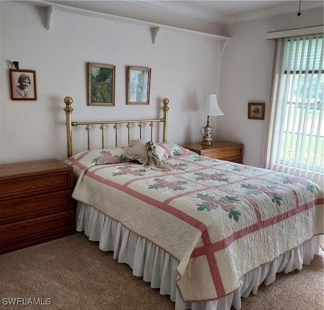 carpeted bedroom with ornamental molding