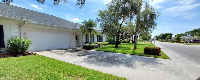 view of front of home with a front lawn and a garage