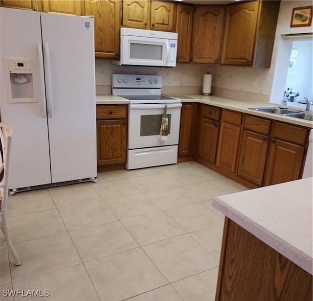 kitchen featuring backsplash, light tile patterned flooring, white appliances, and sink