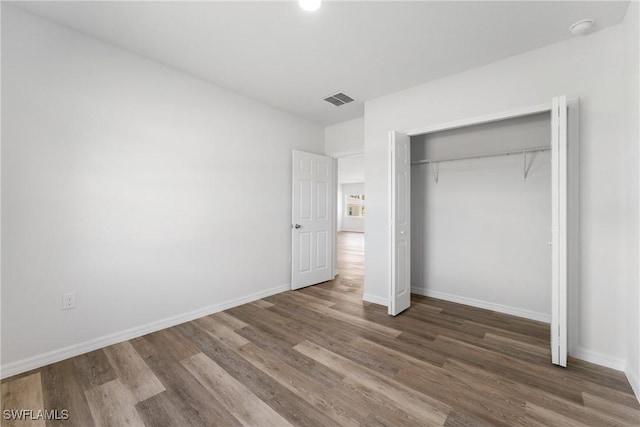 164 Thornton Ave S, Lehigh Acres, FL 33974 - unfurnished bedroom with dark hardwood / wood-style floors and a closet