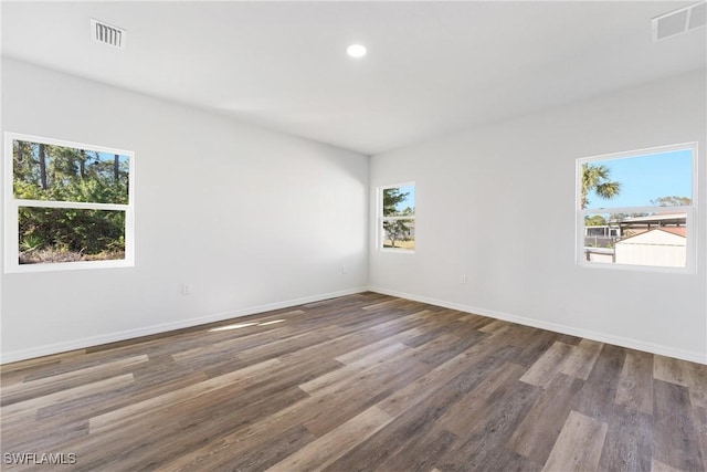164 Thornton Ave S, Lehigh Acres, FL 33974 - spare room featuring hardwood / wood-style flooring and a wealth of natural light