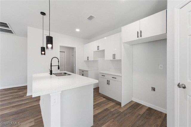 164 Thornton Ave S, Lehigh Acres, FL 33974 - kitchen featuring white cabinetry, hanging light fixtures, dark hardwood / wood-style flooring, and sink