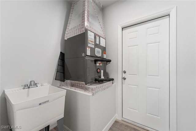 164 Thornton Ave S, Lehigh Acres, FL 33974 - laundry area featuring heating unit and sink