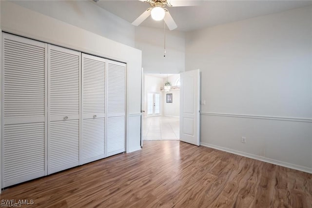 unfurnished bedroom with a closet, ceiling fan, and hardwood / wood-style floors