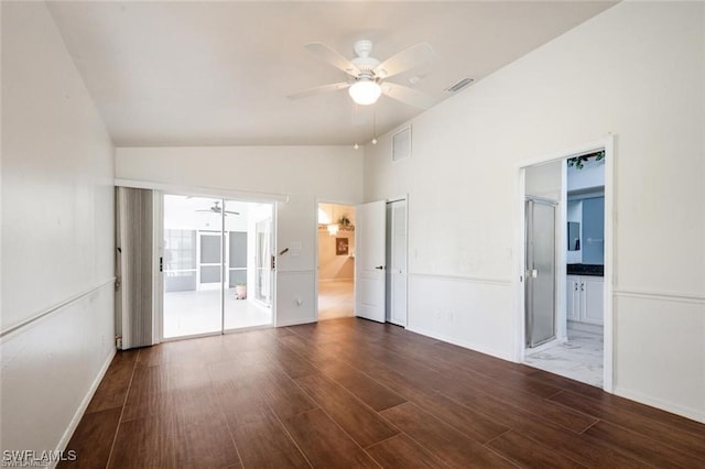 unfurnished room with vaulted ceiling, ceiling fan, and dark hardwood / wood-style flooring