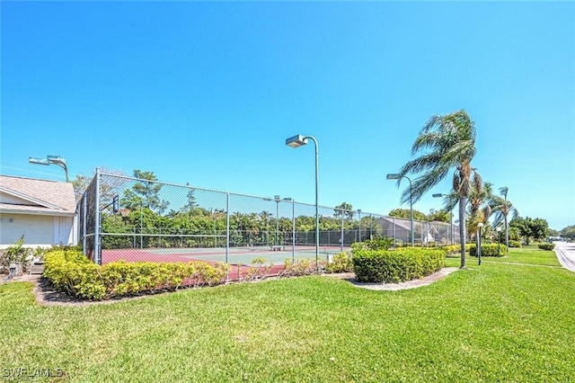 view of tennis court with a lawn