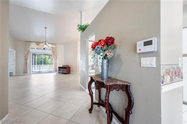 entryway with light tile patterned flooring and ceiling fan