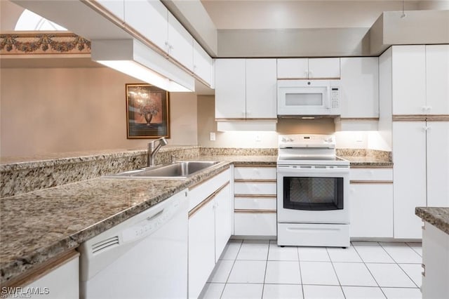 kitchen with white appliances, light tile patterned floors, and white cabinets