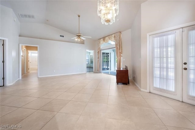 unfurnished living room featuring high vaulted ceiling, ceiling fan with notable chandelier, and light tile patterned floors