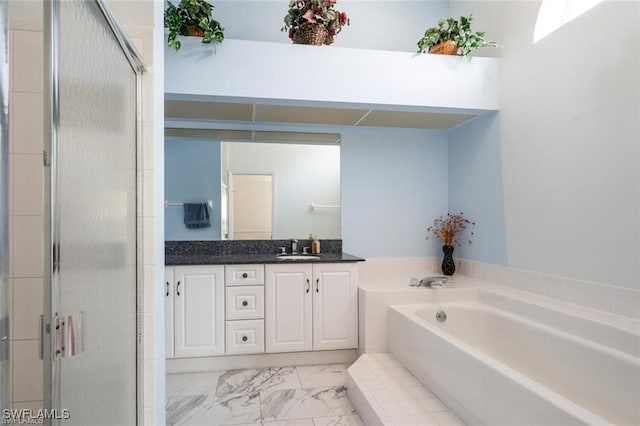 bathroom with vanity and independent shower and bath