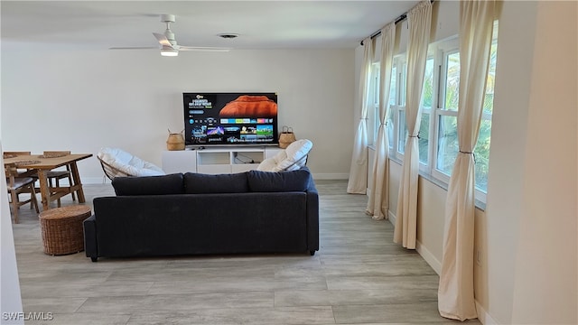 living room featuring ceiling fan and light wood-type flooring