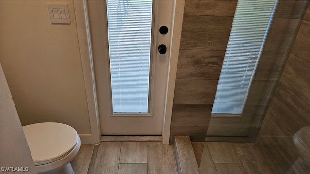 bathroom with toilet and wood-type flooring