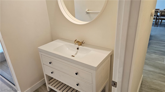 bathroom with vanity and hardwood / wood-style floors