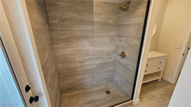 bathroom with vanity, tile patterned floors, and a tile shower