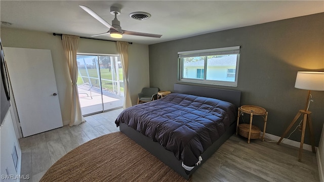 bedroom featuring ceiling fan, access to outside, multiple windows, and light wood-type flooring