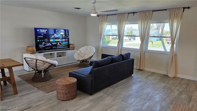 living room featuring light hardwood / wood-style floors and ceiling fan