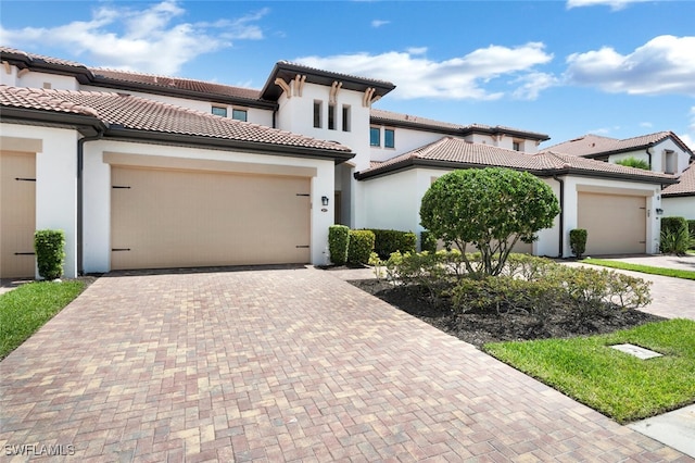 mediterranean / spanish home with a garage